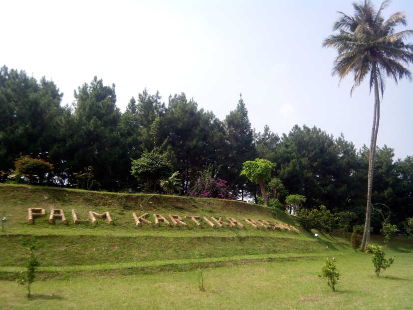 Palm Kartika's logo di atas bukit