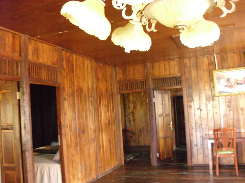 Living room of a 4-bedroom wooden-house with decorative ceiling light